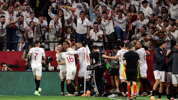 Sevilla's Loic Bade is mobbed after scoring his team's second goal