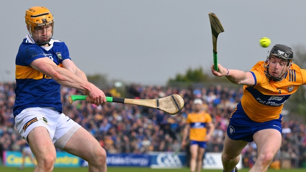 Jake Morris gets his shot away despite the efforts of Tony Kelly