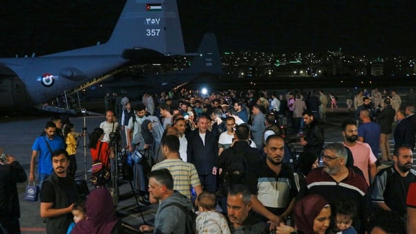 People evacuated from Sudan arrive at a military airport in Amman, Jordan