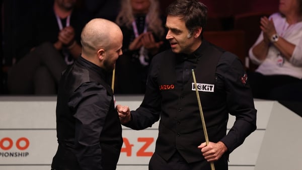 Ronnie O'Sullivan congratulates Luca Brecel after the Belgian fought back to beat him