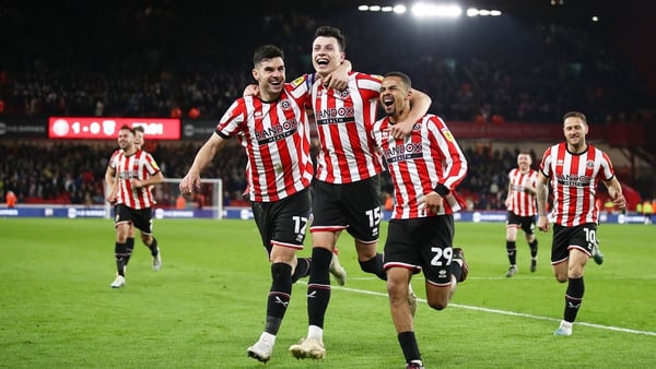 John Egan (left) and his Blades team-mates are going back to the Premier League