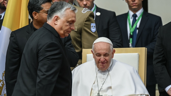 Hungary's Prime Minister Viktor Orban walks past Pope Francis during a welcoming ceremony at Sandor Palace in Budapest