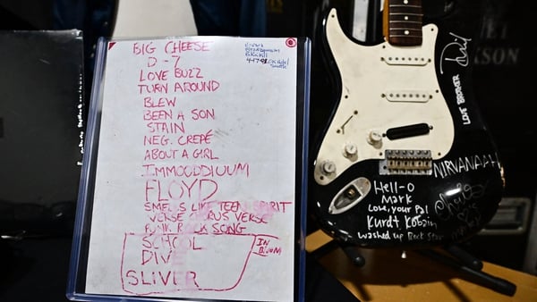 Kurt Cobain's smashed Fender Stratocaster is displayed beside the 1991 Smells Like Teen Spirit debut performance set list at Julien's Auctions in California