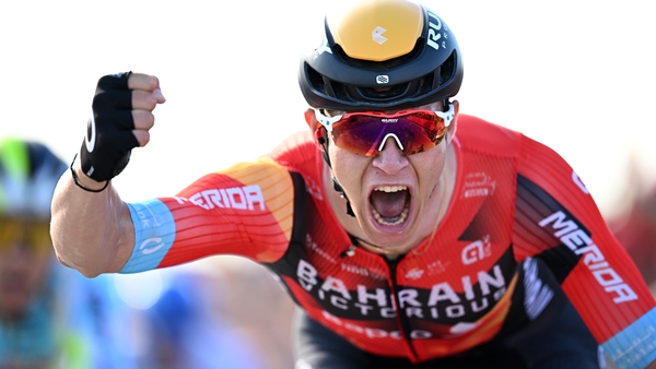 Jonathan Milan celebrates at the finish line on home soil