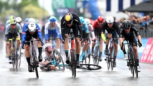 Kaden Groves (L) and Jonathan Milan (C) sprint for the finish line as Mark Cavendish is brought down