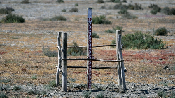 This picture taken on 11 May shows a water level measuring bar on the dry bottom of the Lucio del Lobo pool, at the Donana National Park in Aznalcaraz, southern Spain