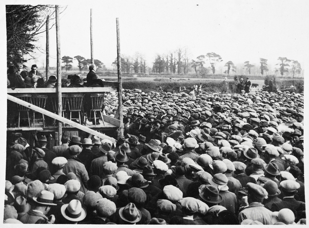 The Liam Lynch Anniversary Commemoration at Fermoy on Sun 13 April 1924. The photo shows Sean T. O'Kelly delivering an oration to a vast crowd in the field at the back of the graveyard. Image courtesy of the National Library of Ireland