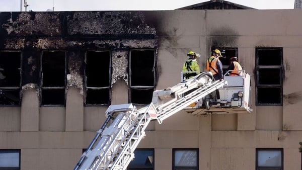 Firefighters inspect the hostel in Wellington