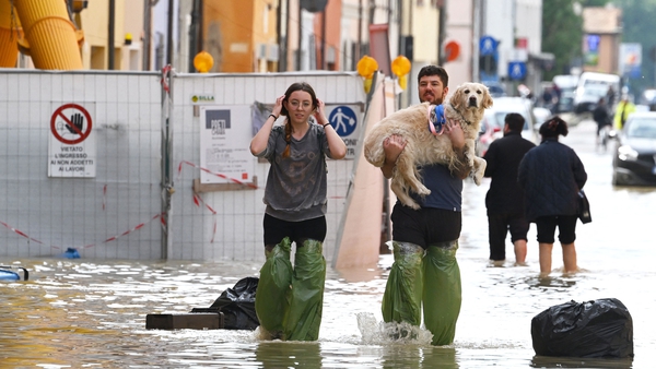 Pedestrians on a flooded street in the town of Lugo