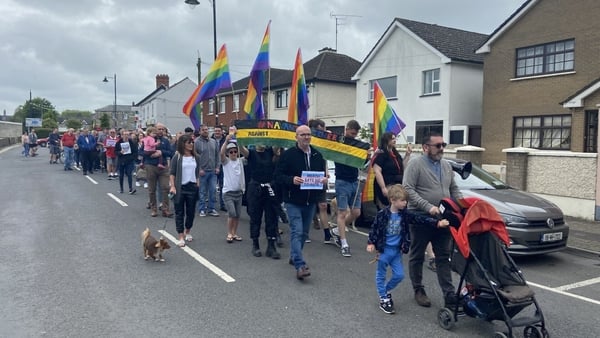 Those who took part in the event walked through the town carrying Pride flags and holding signs