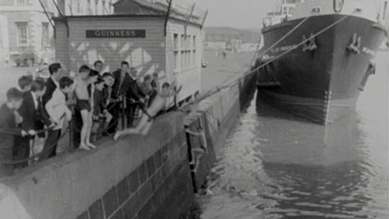 A boy dives into the River Liffey at Custom House Quay, 1963