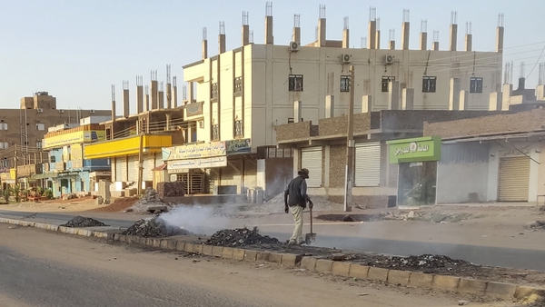 A man in the Sudanese capital Khartoum burning rubbish he collected while cleaning a street during the ceasefire