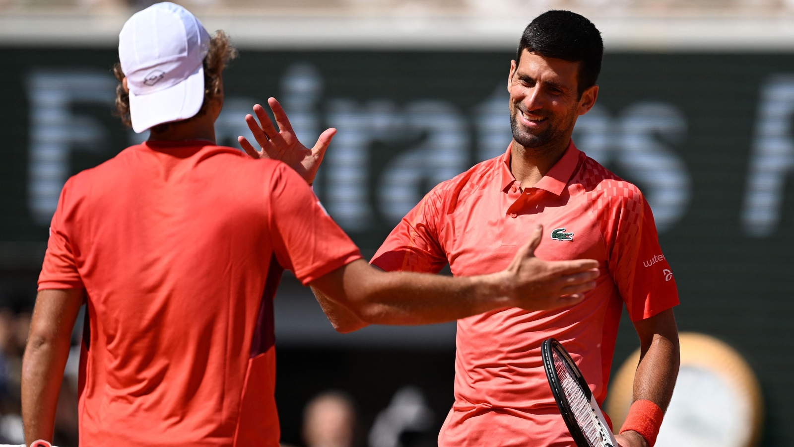 Djokovic advances and then sends political message