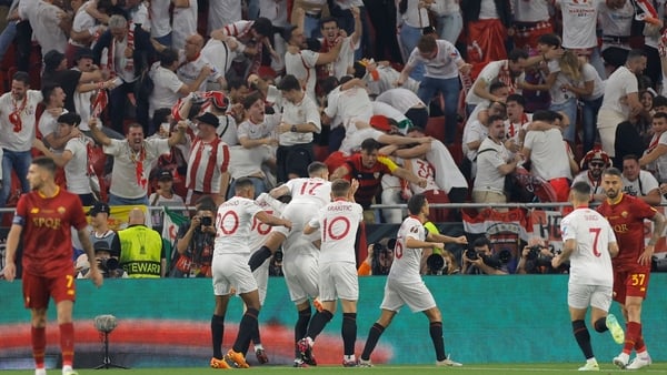 Sevilla players celebrate their equaliser against Roma, an own goal by defender Mancini