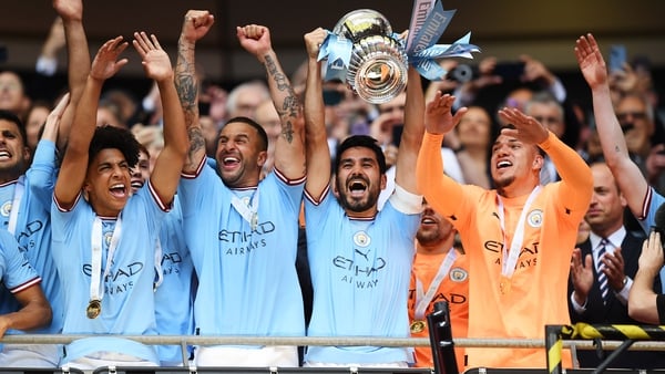 Ilkay Gundogan hoists the FA Cup as Manchester City secured the double at Wembley