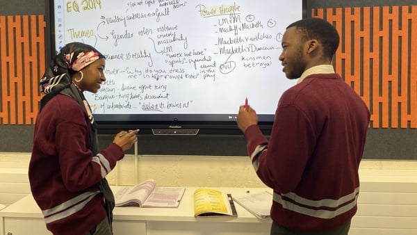 Fatima Ismail and Presley Jeche use a whiteboard for Macbeth revision