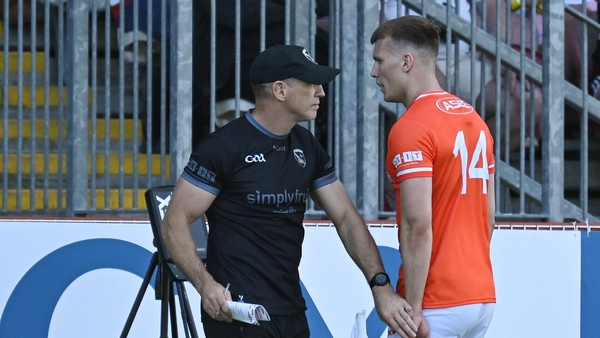 Rian O'Neill walks past manager Kieran McGeeney after being shown a red card