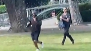 A video obtained by AFPTV shows a man armed with a knife (L) running away after he attacked a group of children playing in Annecy