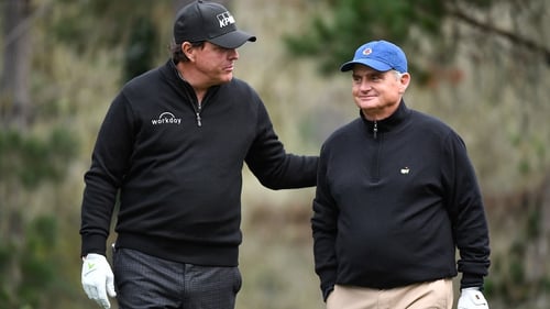 Phil Mickelson pats Jimmy Dunne on the back during the AT&T Pebble Beach Pro-Am in 2019