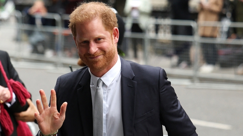 Britain's Prince Harry, Duke of Sussex, waves as he arrives at the Royal Courts of Justice