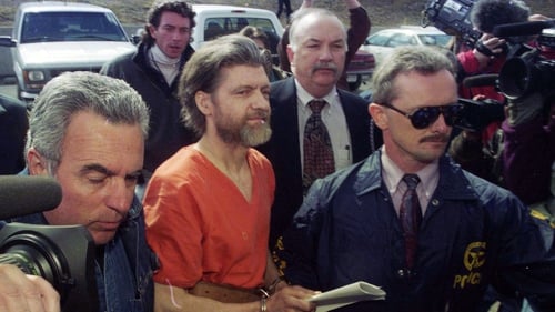Theodore "Ted" Kaczynski is guided to his arraignment by federal marshals in Helena, Montana on 4 April, 1996