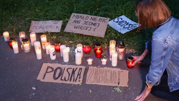 People light candles at a demonstration against Poland's restrictive abortion laws