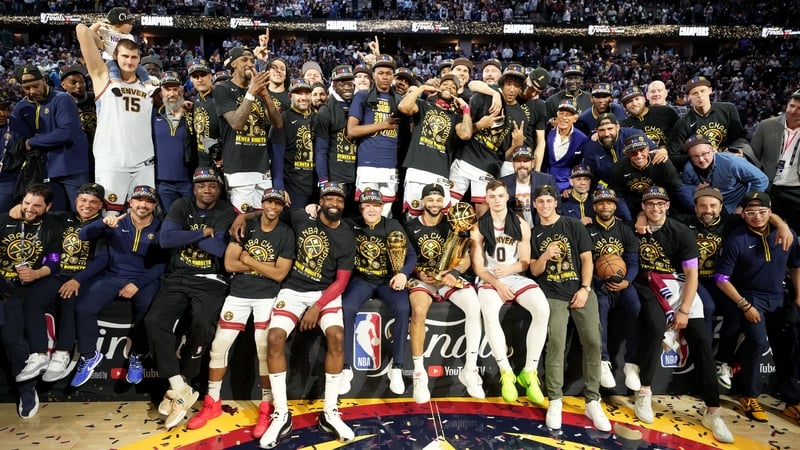 The Denver Nuggets celebrate with the Larry O'Brien and Bill Russell MVP trophies