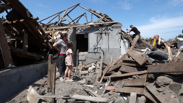 People stand in the debris of former homes in the aftermath of a Russian attack on Kramatorsk
