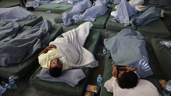 People rest after being rescued from the shipwreack in Greece last week