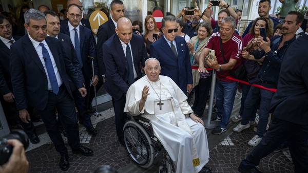 Pope Francis waves to well-wishers as he leaves Gemelli hospital