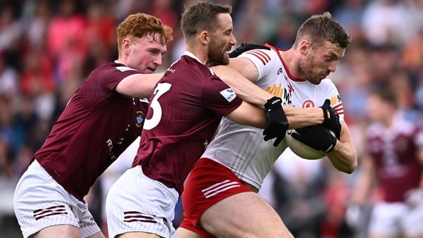 Tyrone's Brian Kennedy is challenged by Westmeath captain and full-back Kevin Maguire