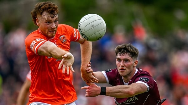 Jason Duffy of Armagh (L) battles for possession with Cathal Sweeney