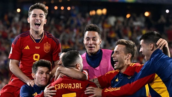 Spain's players celebrate after winning the penalty shootout