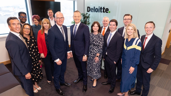 Simon Coveney, Minister for Enterprise, Trade and Employment and Harry Goddard, CEO Deloitte Ireland with Cork based partners in Deloitte offices, Cork
