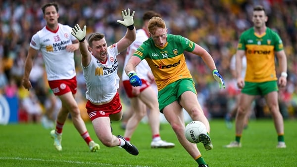 Oisin Gallen of Donegal is challenged by Tyrone's Michael O'Neill