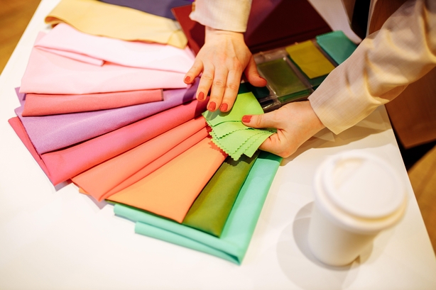 stylist looking at swatches of fabric