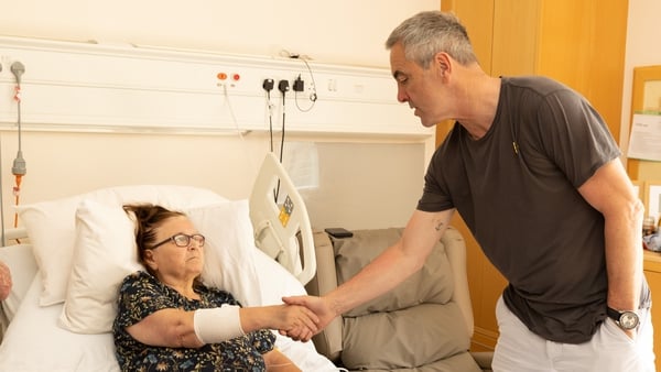 James Nesbit shaking hands with patient Catherine Wilson from Downpatrick, during his visit to Marie Curie's Belfast hospice