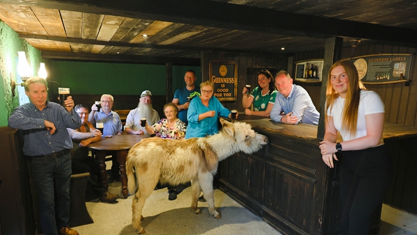 Luke Mee (behind the bar) is joined by family and friends at the opening of the newly restored pub