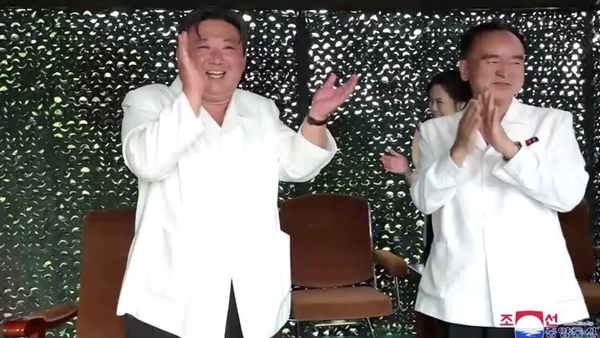Kim Jong Un (L) was shown applauding enthusiastically after the launch
