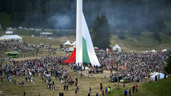 People watch the rising of a large Bulgarian flag during preparations ahead of the event