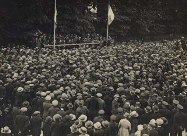 Crowds at an election rally in St. Stephen's Green, 1923. Seated on the platform are, amongst others, Eoin MacNeill, Hugh Kennedy and W. T. Cosgrave. The speaker addressing the crowd may be Kevin O'Higgins. CA. 1923 Photo: National Library of Ireland
