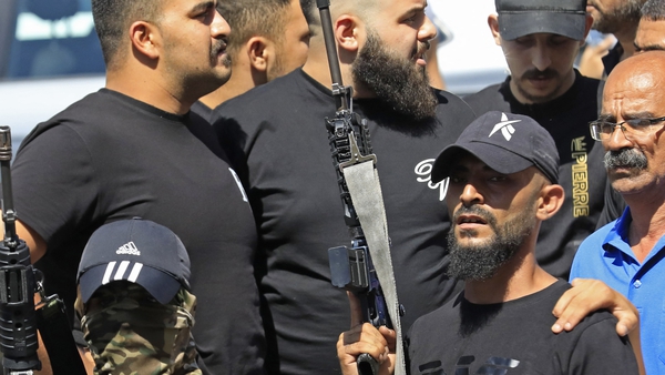 Armed militants at a West Bank funeral, amid warnings that the judicial crisis is distracting Israel from escalating violence
