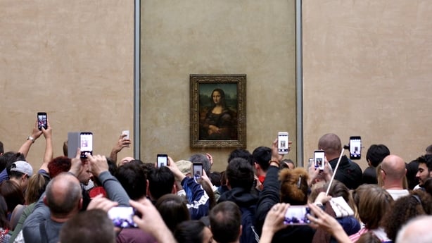 Visitors take pictures of 'La Joconde', a 1503-1506 oil on wood portrait of Mona Lisa by Leonardo Da Vinci, at the Louvre Museum in Paris, on April 9, 2018. ( Photo by Pedro Fiúza/NurPhoto)