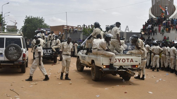 Nigerien policemen are seen as supporters rally in support of Niger's junta in Niamey