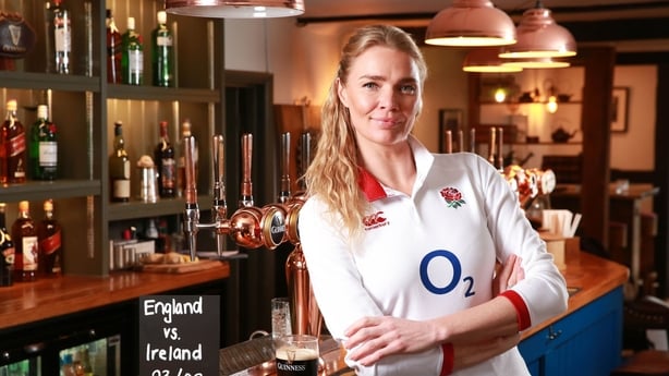 Jodie Kidd standing at the bar in her pub