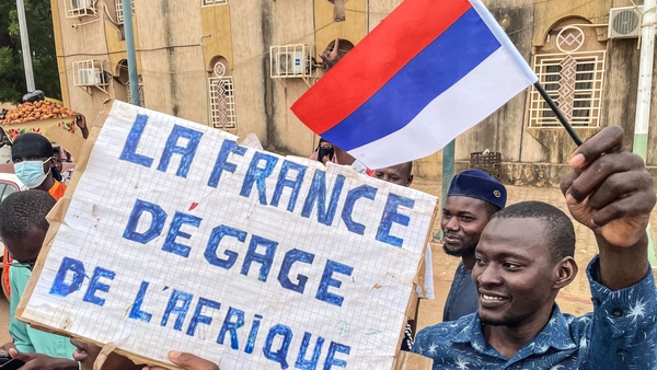 Protesters hold an anti-France placard during a demonstration on Niger's independence day in Niamey