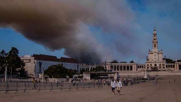 Smoke from the wildfires pictured billowing over the Catholic shrine of Fatima yesterday
