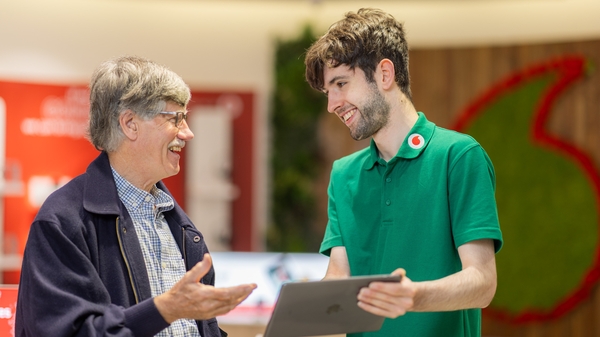 Peter Kelly, Vodafone customer and Jack Moran, Vodafone employee at the Dundrum store in Dublin