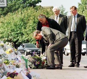 Prince Charles lays a wreath at the bomb scene in Omagh. Northern Ireland Secretary Mo Mowlan and First Minister of the Northern Ireland Assembly, David Trimble (R), are also pictured