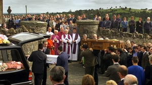 The coffins of Avril Monaghan and her 18 month-old daughter Maura are taken into the church in Augher, with thousands in attendance
